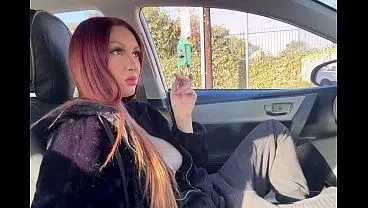 Artemisia Love smoking a cigarette in the car